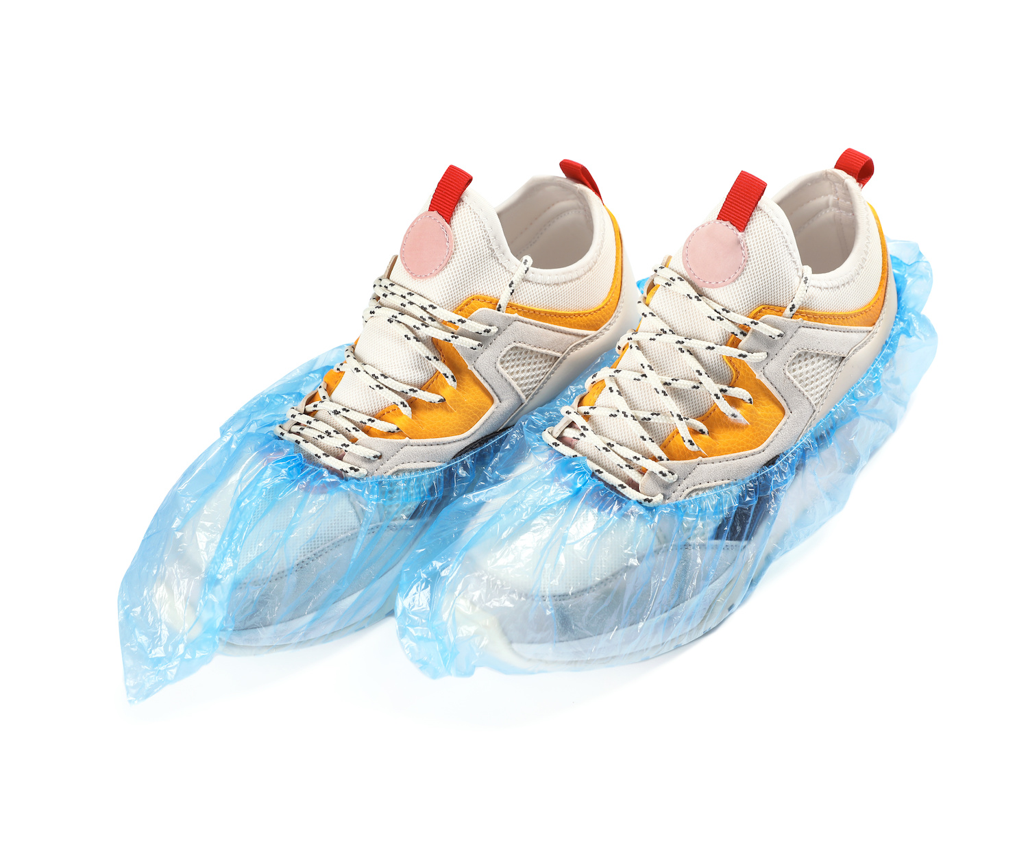 Pair of sneakers in medical blue covers on white background